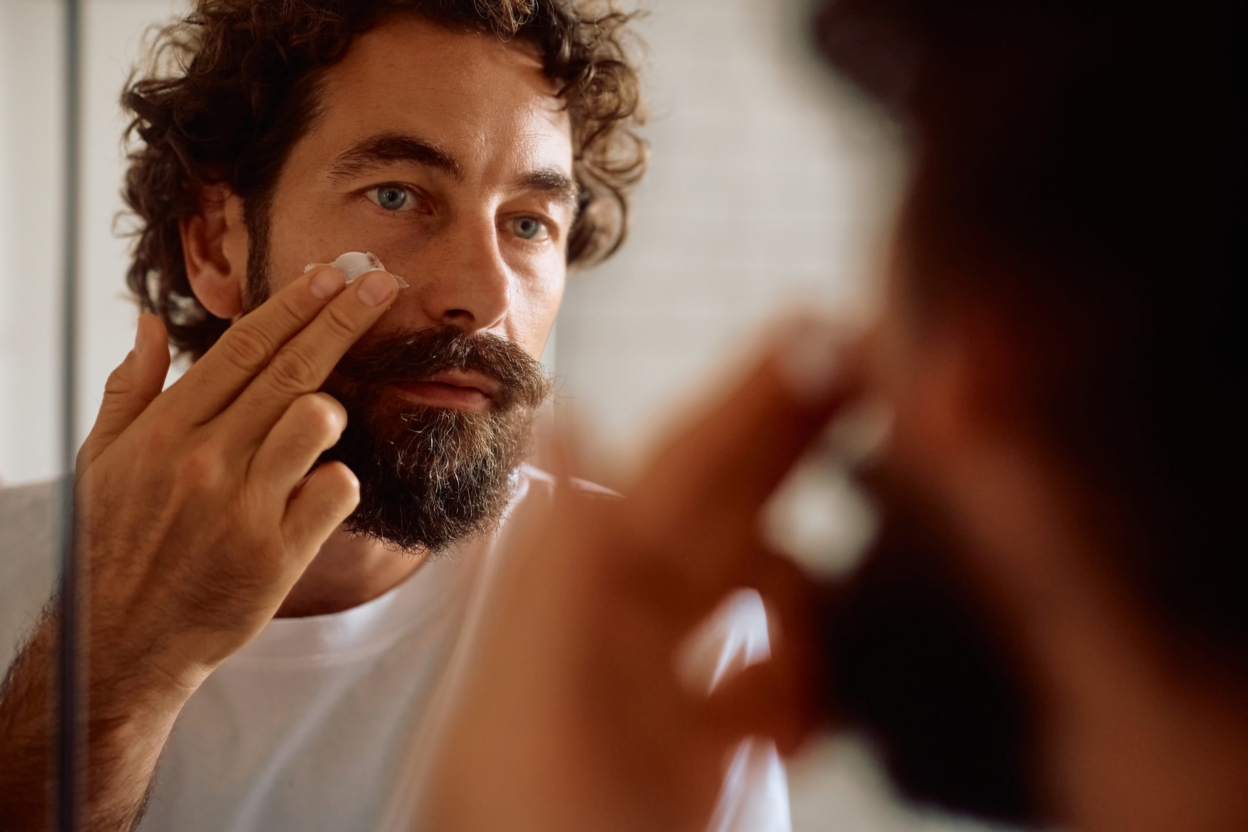 Man considering Australian skincare products, active skincare and the best moisturiser for dry skin in his daily routine.